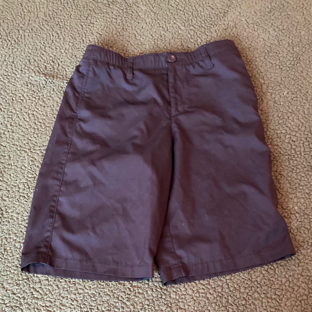 Boy UA black golf shorts.